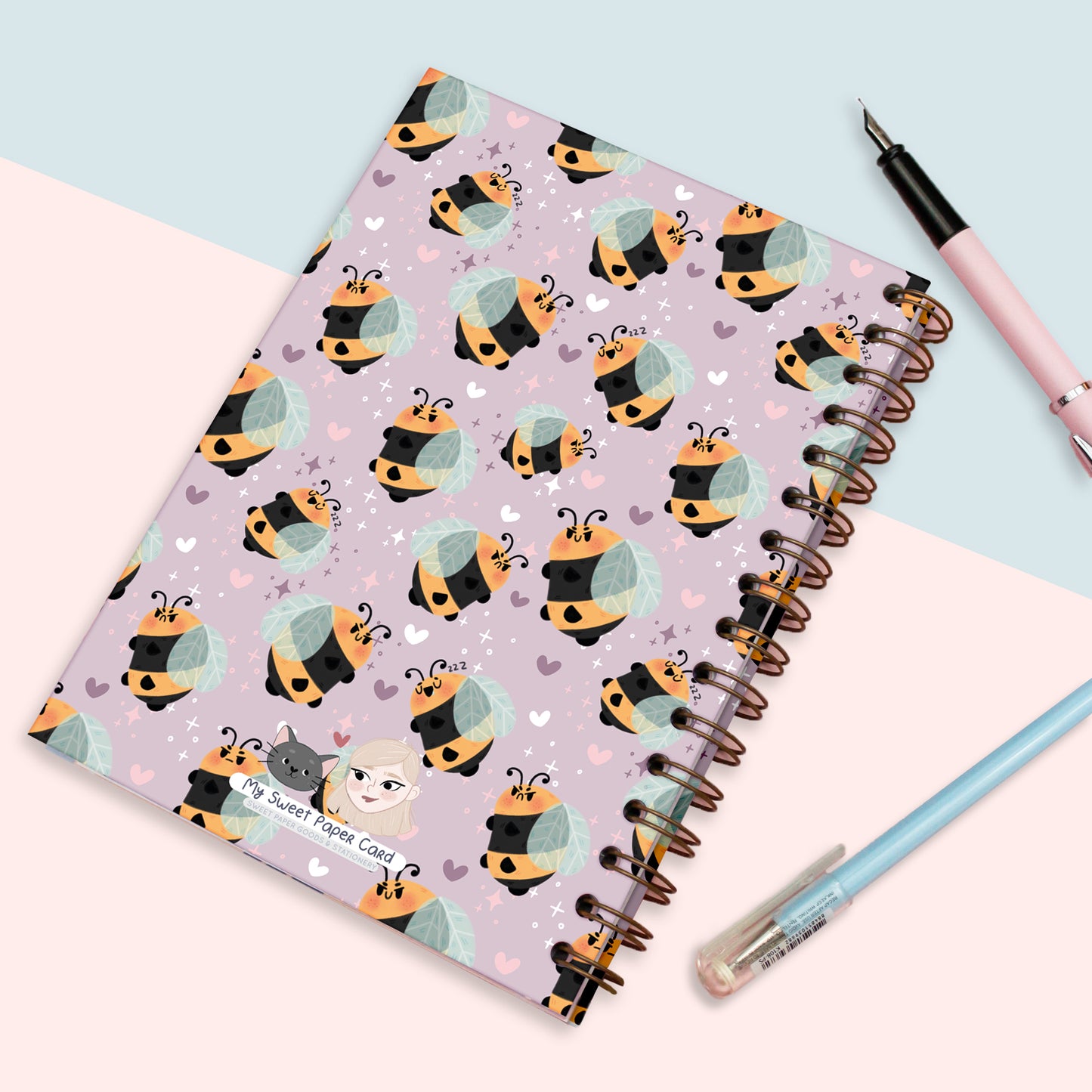 cute purple spiral bullet journal with grumpy bees on the cover
